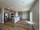 Modern kitchen features an island, stainless steel appliances, and ample gray cabinetry at 18328 E 93Rd Pl, Commerce City, CO 80022