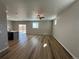 Open concept living area with wood floors, modern lighting and natural light at 18328 E 93Rd Pl, Commerce City, CO 80022