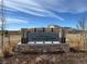 Second Creek Farm community sign with stone base and landscaped surroundings at 18328 E 93Rd Pl, Commerce City, CO 80022