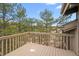 Wood deck overlooks pine trees and distant mountains at 7635 Red Rock Cir, Larkspur, CO 80118