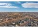 Expansive aerial shot of a residential community near green spaces, ponds, and a major roadway at 5480 Danube St, Denver, CO 80249