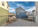 Spacious gray back deck with metal railing with a view of surrounding neighborhood homes at 5480 Danube St, Denver, CO 80249