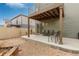 Charming backyard featuring a covered patio with seating, string lights, and a gravel area for gardening at 5480 Danube St, Denver, CO 80249