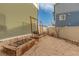 Spacious backyard with gravel landscaping, raised garden beds, and supports for climbing plants at 5480 Danube St, Denver, CO 80249