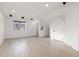 Finished basement area with new LVP flooring and recessed lighting and a window at 5480 Danube St, Denver, CO 80249