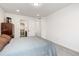 Bright bedroom with carpet flooring, a gray bed, and white trim at 5480 Danube St, Denver, CO 80249