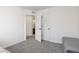 Bright bedroom with neutral carpet and a view to the bathroom at 5480 Danube St, Denver, CO 80249
