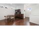 The dining area features hardwood floors, modern furniture and a contemporary chandelier at 5480 Danube St, Denver, CO 80249