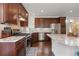 This kitchen features granite countertops, a tile backsplash, stainless steel appliances and dark cabinets at 5480 Danube St, Denver, CO 80249