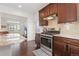 The kitchen features dark cabinets, granite countertops, tile backsplash and stainless steel appliances at 5480 Danube St, Denver, CO 80249