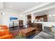 Open concept living room showing kitchen, tv, sofa and colorful rug at 5480 Danube St, Denver, CO 80249