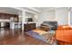 Open-concept living room flows from the kitchen and features wood floors and bright colors at 5480 Danube St, Denver, CO 80249
