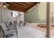 Relaxing covered patio featuring concrete floors, stylish seating, and string lights, perfect for outdoor enjoyment at 5480 Danube St, Denver, CO 80249