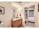 Full bathroom with vanity and access to hallway at 5800 Tower Rd # 103, Denver, CO 80249