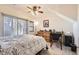 Cozy bedroom featuring a bed, dresser, and sliding door to patio at 5800 Tower Rd # 103, Denver, CO 80249