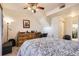 Bright bedroom with a dresser, desk, and a comfy bed at 5800 Tower Rd # 103, Denver, CO 80249