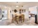 Bright dining area with wooden table and chairs, open concept at 5800 Tower Rd # 103, Denver, CO 80249