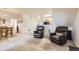 Simple dining area with wooden table and chairs near living room at 5800 Tower Rd # 103, Denver, CO 80249