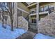 Stone exterior with stairs leading to a private patio at 5800 Tower Rd # 103, Denver, CO 80249