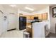 Modern kitchen with wood cabinets, black appliances, and tile flooring at 5800 Tower Rd # 103, Denver, CO 80249