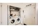 Laundry room with washer, dryer, and storage at 5800 Tower Rd # 103, Denver, CO 80249