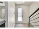 Entryway featuring a modern front door, and a staircase with a black metal railing at 3044 Wilson Ct # 2, Denver, CO 80205