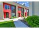 Modern townhome with red accents, large windows, and professional landscaping at 3044 Wilson Ct # 2, Denver, CO 80205