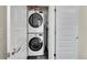 A convenient laundry room boasts a stacked washer and dryer for efficient space utilization at 3044 Wilson Ct # 2, Denver, CO 80205