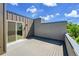 This rooftop deck features a sliding door and ample space for outdoor lounging and relaxation at 3044 Wilson Ct # 2, Denver, CO 80205