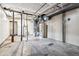 Unfinished basement features water heater, pipes, concrete floor and some wall board at 4940 W 9Th Ave, Denver, CO 80204