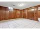 Finished basement with tile floors, wood paneling and a closet at 4940 W 9Th Ave, Denver, CO 80204