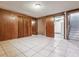 A finished basement featuring tile floors, wood paneled walls and closet at 4940 W 9Th Ave, Denver, CO 80204