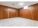 Finished basement offers tile floors, wood paneling and a small window at 4940 W 9Th Ave, Denver, CO 80204