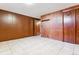 A finished basement with tile floors, wood paneling and closet space at 4940 W 9Th Ave, Denver, CO 80204