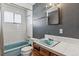 Full bathroom with tile surround, vanity, and classic fixtures at 4940 W 9Th Ave, Denver, CO 80204