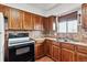 Cozy kitchen featuring ample cabinet space and a bright window at 4940 W 9Th Ave, Denver, CO 80204