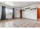 Bright living room with tile flooring, shelves, and natural light at 4940 W 9Th Ave, Denver, CO 80204