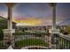 Enjoy breathtaking sunset views from this relaxing balcony complete with stone pillars and iron railings at 10698 Mountaingate Ct, Littleton, CO 80126