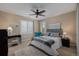 Bright bedroom features neutral decor, plantation shutters, ceiling fan, and modern furnishings at 10698 Mountaingate Ct, Littleton, CO 80126
