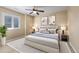 Serene bedroom with neutral tones, a ceiling fan, modern decor, and natural light at 10698 Mountaingate Ct, Littleton, CO 80126