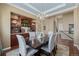 Formal dining room boasts elegant chandelier, hutch, and stylish seating, perfect for entertaining at 10698 Mountaingate Ct, Littleton, CO 80126