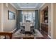 Elegant dining room featuring hardwood floors, a chandelier, and ample natural light for formal gatherings at 10698 Mountaingate Ct, Littleton, CO 80126