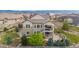 Well-manicured two-story home boasts a beautiful exterior with stone accents, a covered balcony, and a spacious patio at 10698 Mountaingate Ct, Littleton, CO 80126