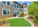 Beautiful home exterior featuring a lush lawn, stone accents, and an inviting staircase to the upper level at 10698 Mountaingate Ct, Littleton, CO 80126