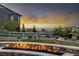 Outdoor fire pit provides a cozy spot with panoramic views during sunset at 10698 Mountaingate Ct, Littleton, CO 80126