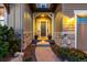 Inviting front entrance features stone accents, manicured landscaping, and a well-lit walkway for a welcoming feel at 10698 Mountaingate Ct, Littleton, CO 80126