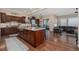 Gourmet kitchen with hardwood floors, stainless steel appliances, and a large center island with seating at 10698 Mountaingate Ct, Littleton, CO 80126