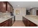 Modern kitchenette equipped with stainless steel appliances, granite countertops, and mosaic tile backsplash at 10698 Mountaingate Ct, Littleton, CO 80126