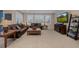 Cozy living room featuring plush seating, plantation shutters, and modern entertainment setup at 10698 Mountaingate Ct, Littleton, CO 80126