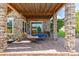 Inviting outdoor patio with stone columns, wood beams, and a relaxing hammock at 10698 Mountaingate Ct, Littleton, CO 80126